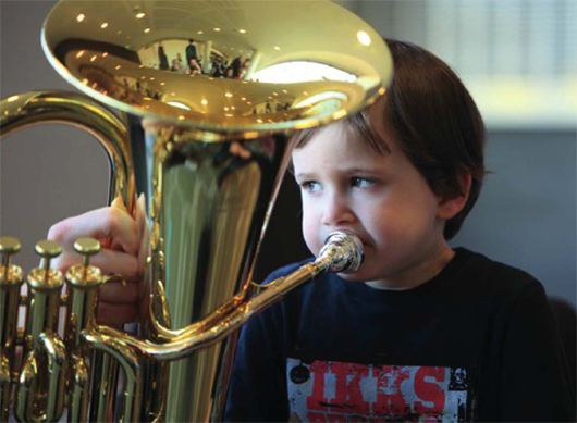 Young boy playing a tuba